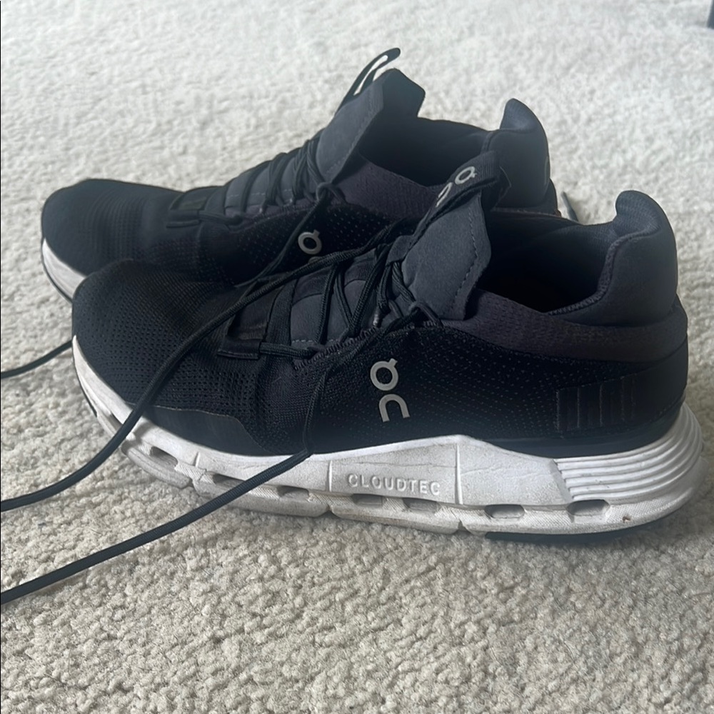 On Running Black and White Athletic Shoes with Streamlined Design